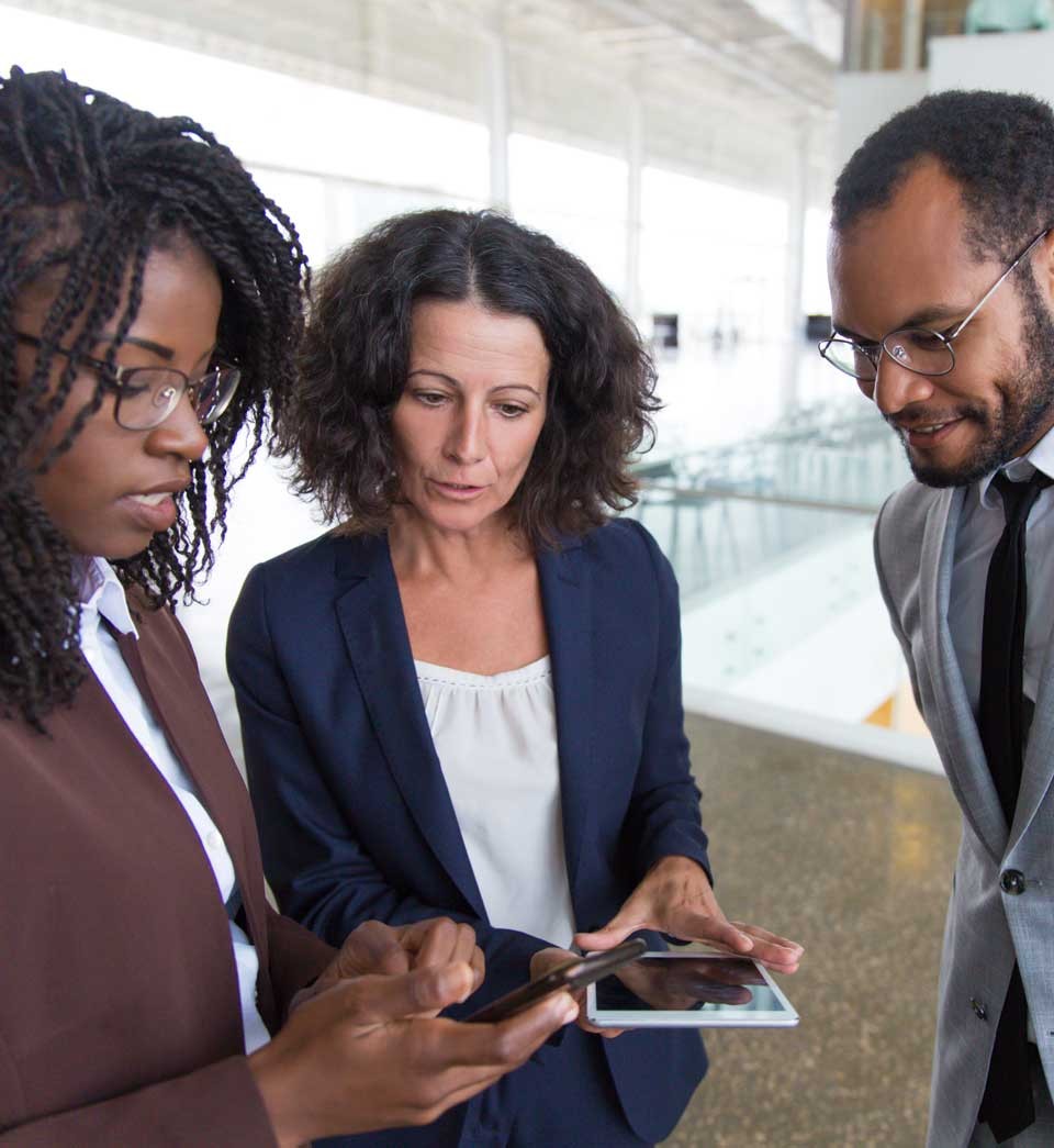 Business team consulting internet on digital devices together Business team consulting internet on digital devices together
