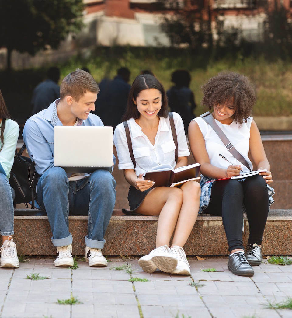 Group of happy teen high school students studying outdoors Group of happy teen high school students studying outdoors