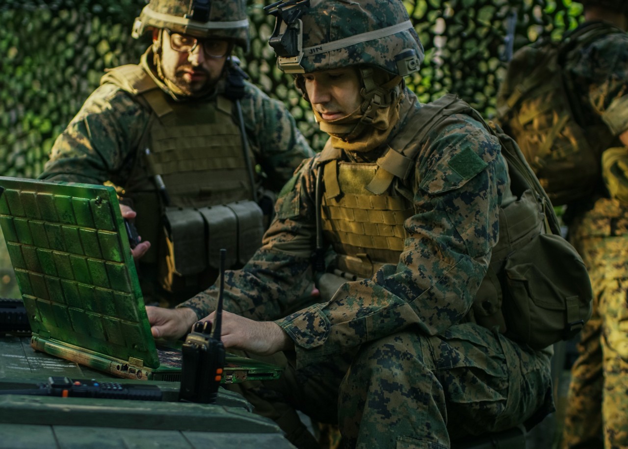 Military Staging Base, Officer Gives Orders to Chief Engineer, They Use Radio and Army Grade Laptop. They're in Camouflaged Tent in a Forest. They're on Reconnaissance Operation/ Mission. Military Staging Base, Officer Gives Orders to Chief Engineer, They Use Radio and Army Grade Laptop. They're in Camouflaged Tent in a Forest. They're on Reconnaissance Operation/ Mission.