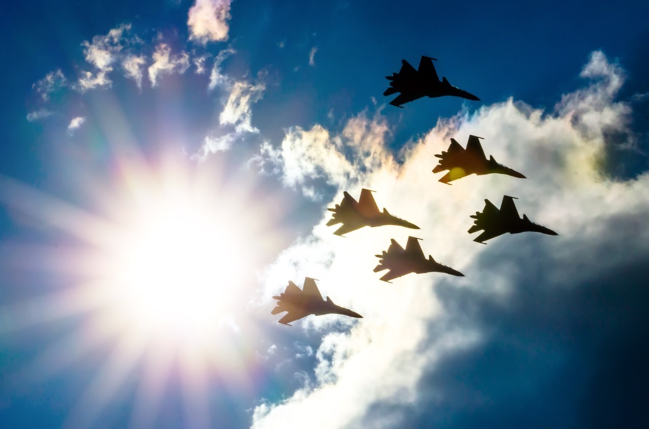 Group of fighter jet airplane sun glow blue sky Group of fighter jet airplane sun glow blue sky