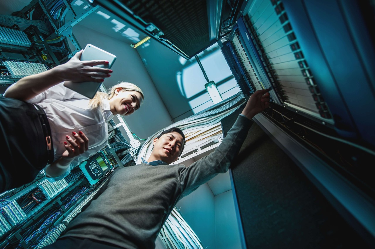 Two people working on the security of a service provider data center. Two people working on the security of a service provider data center.